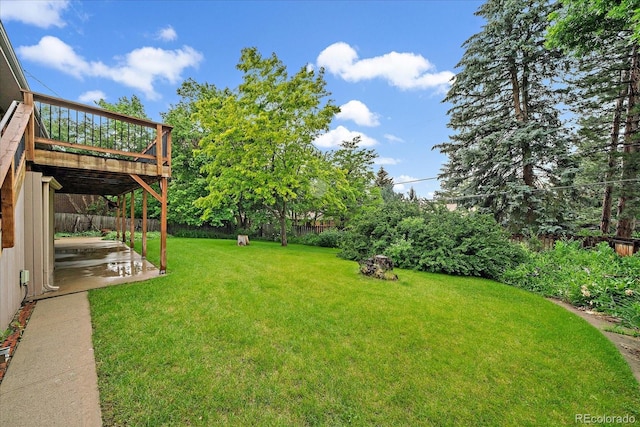 7077 Dudley Dr, Arvada, CO 80004 - view of yard with a wooden deck and a patio