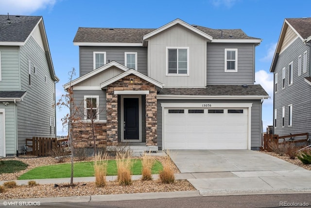 15076 W 93rd Ave, Arvada, CO 80007 - view of front facade featuring driveway, board and batten siding, stone siding, an attached garage, and a shingled roof