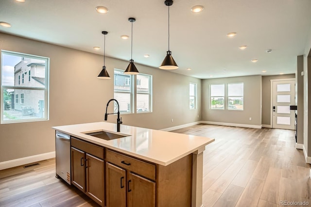 2491 W 69th Pl, Denver, CO 80221 - kitchen featuring light wood-style flooring, hanging light fixtures, brown cabinetry, recessed lighting, and light countertops