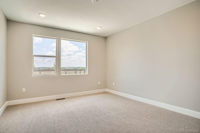 2491 W 69th Pl, Denver, CO 80221 - spare room with light colored carpet and recessed lighting