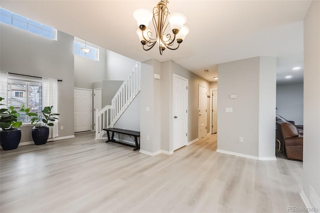 living room with light wood-type flooring and an inviting chandelier