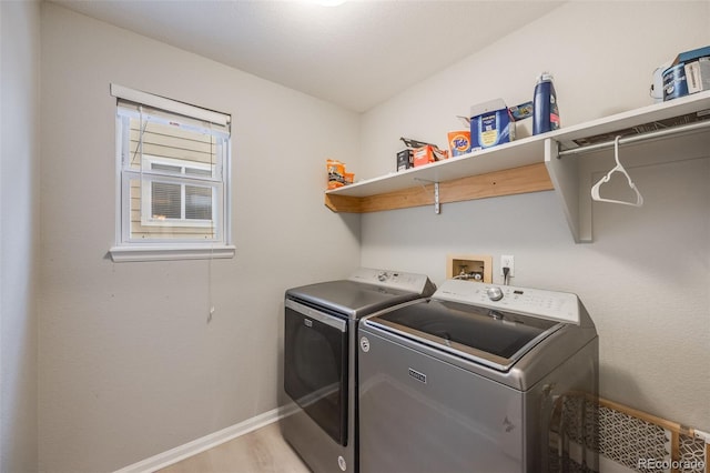 washroom featuring independent washer and dryer and light hardwood / wood-style flooring