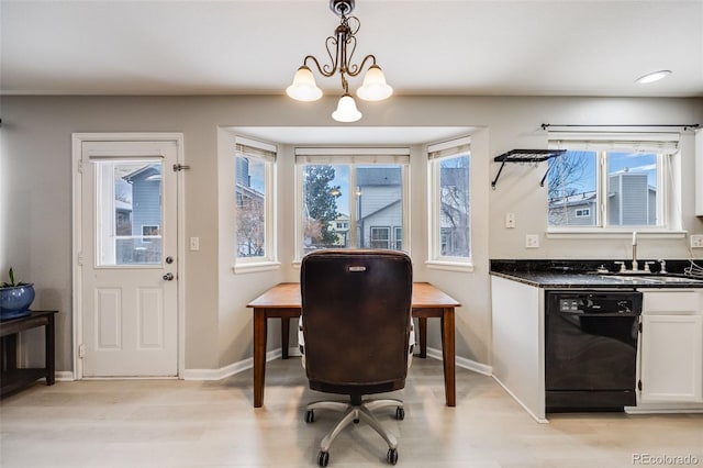 office space with light wood-type flooring, a notable chandelier, and sink