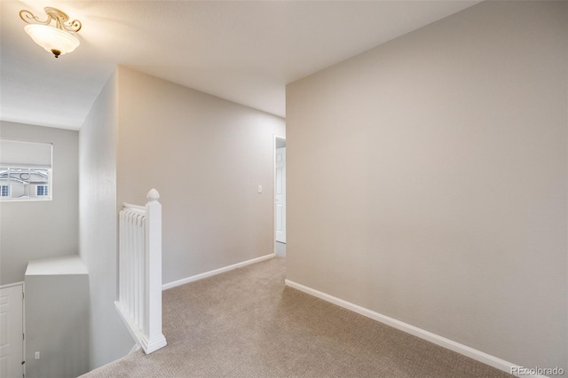 corridor with light colored carpet