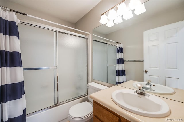 full bathroom with vanity, toilet, and enclosed tub / shower combo