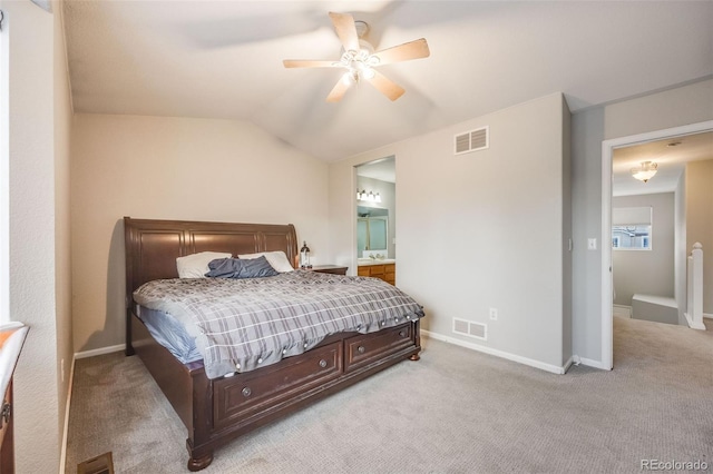 carpeted bedroom with vaulted ceiling, ensuite bath, and ceiling fan