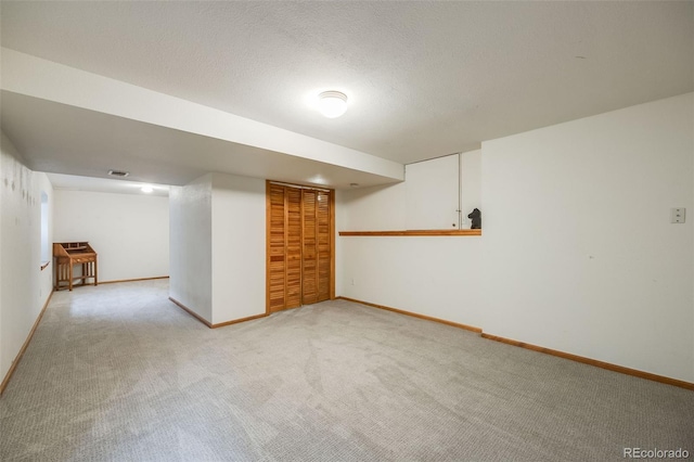 basement featuring light colored carpet