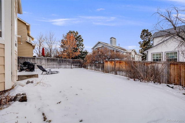 view of yard layered in snow