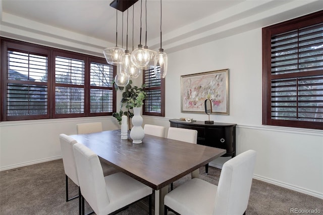 dining room with baseboards, carpet flooring, and a chandelier