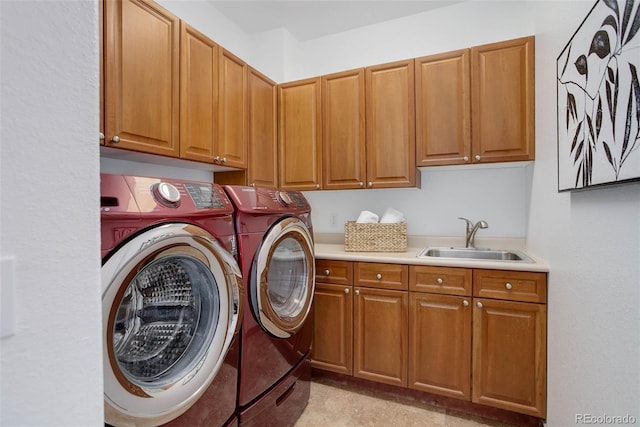 laundry area with independent washer and dryer, a sink, and cabinet space