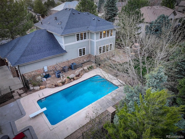 view of swimming pool with fence, a fenced in pool, cooling unit, and a patio area