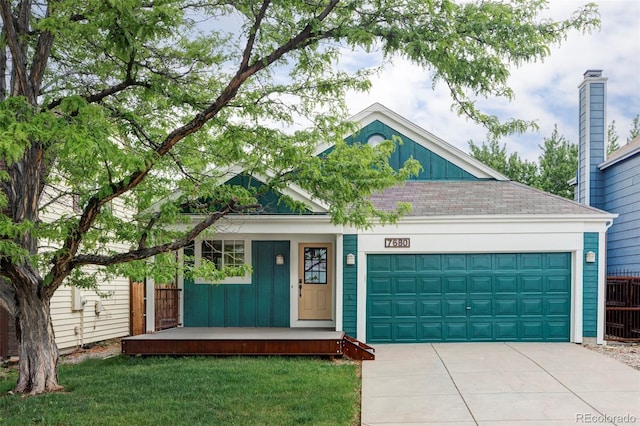 7680 Elmwood St, Littleton, CO 80125 - view of front of property featuring board and batten siding, driveway, an attached garage, a porch, and a front yard