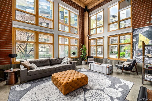 2955 Inca St Unit 1H, Denver, CO 80202 - living room with concrete flooring, a high ceiling, and a wood ceiling with exposed beams