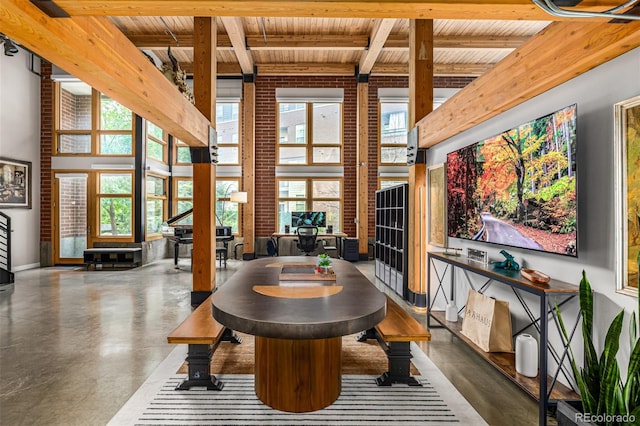 2955 Inca St Unit 1H, Denver, CO 80202 - dining room featuring a wood ceiling with exposed beams, a high ceiling, plenty of natural light, and finished concrete flooring