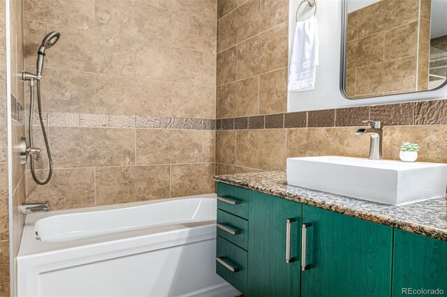 2955 Inca St Unit 1H, Denver, CO 80202 - bathroom featuring vanity, shower / bathtub combination, and tile walls