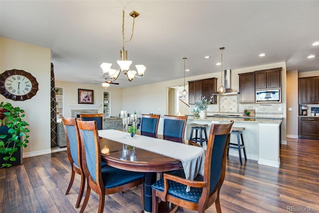 dining area with recessed lighting, baseboards, dark wood-style flooring, and a fireplace