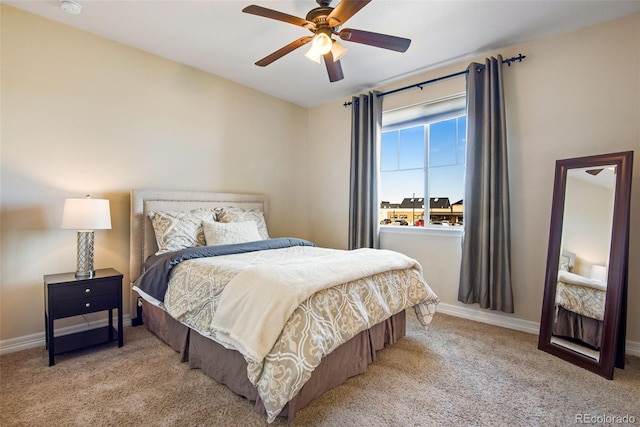 bedroom with baseboards, carpet, and a ceiling fan