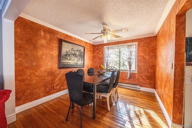 dining area featuring hardwood / wood-style flooring, ornamental molding, a textured ceiling, and a baseboard heating unit