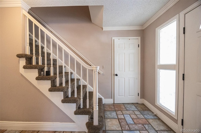 staircase with crown molding, a textured ceiling, and a healthy amount of sunlight