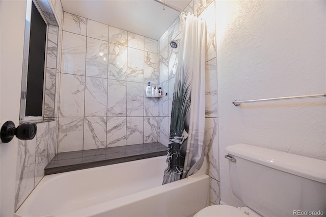 bathroom with toilet and shower / tub combo