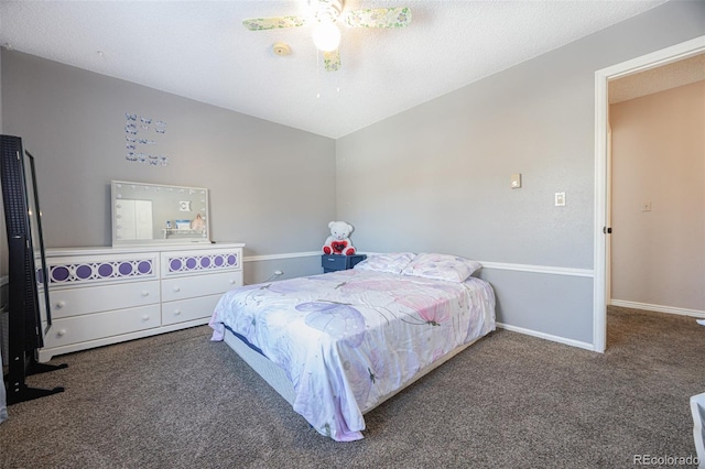 bedroom featuring ceiling fan, lofted ceiling, dark carpet, and a textured ceiling