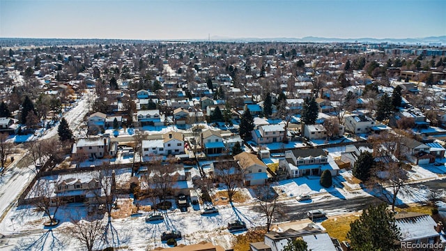 snowy aerial view featuring a mountain view