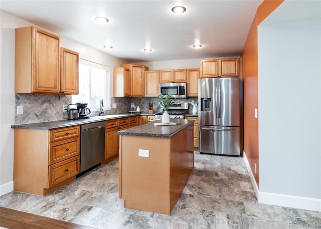 kitchen featuring stainless steel appliances, a center island, tasteful backsplash, and dark countertops