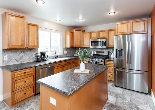 kitchen with appliances with stainless steel finishes, a center island, a sink, and decorative backsplash