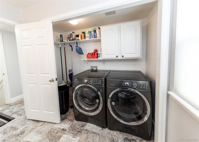 clothes washing area featuring cabinet space, independent washer and dryer, and visible vents