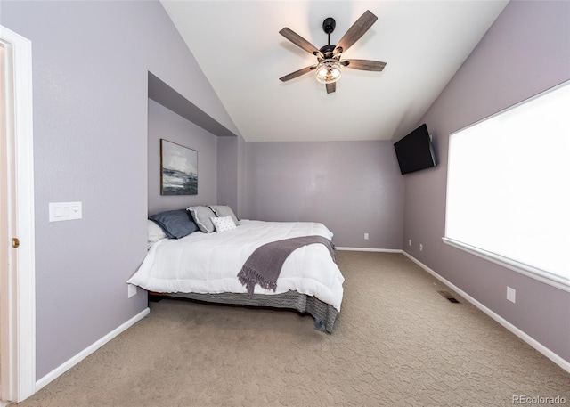 carpeted bedroom with visible vents, baseboards, lofted ceiling, and ceiling fan