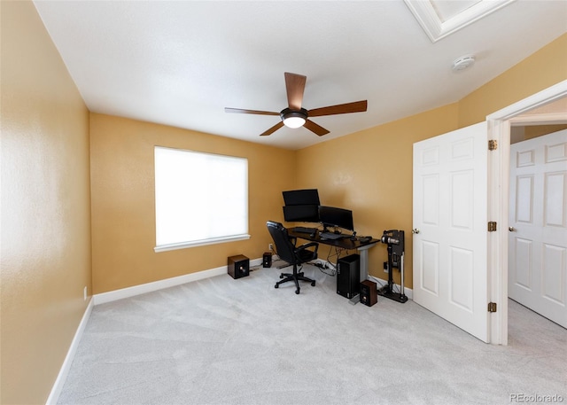 home office featuring ceiling fan, light colored carpet, and baseboards