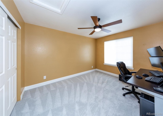 office area featuring light carpet and baseboards