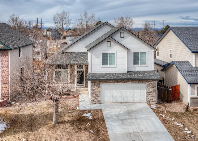 view of front of property featuring roof with shingles, stone siding, concrete driveway, and an attached garage