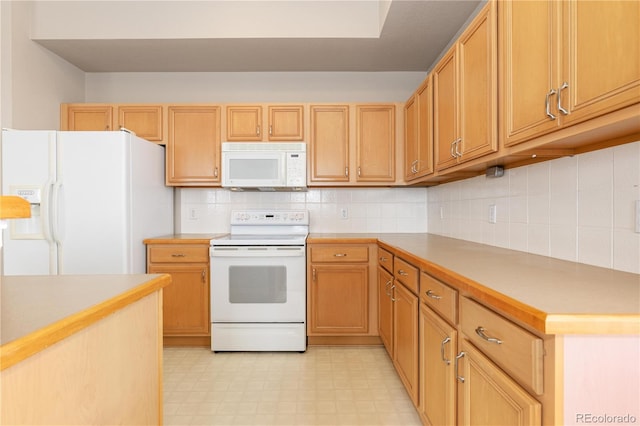 kitchen with white appliances and backsplash