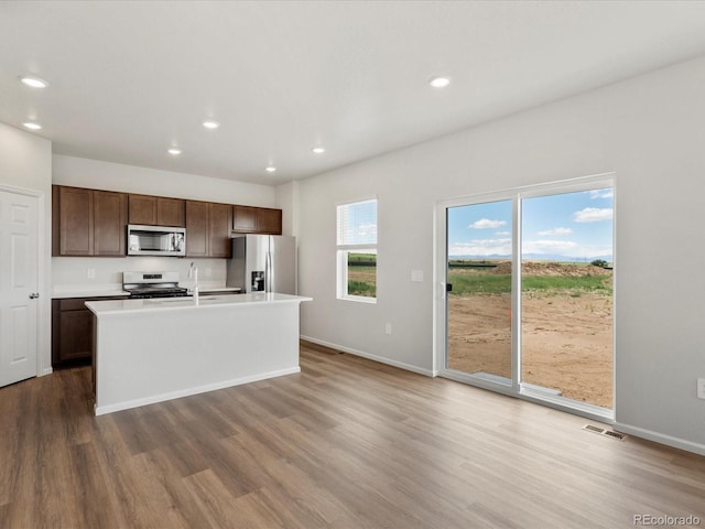 2717 73rd Avenue Ct, Greeley, CO 80634 - kitchen with stainless steel appliances, wood finished floors, recessed lighting, light countertops, and baseboards