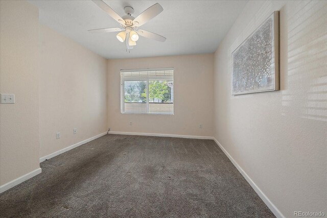 unfurnished room featuring a ceiling fan, carpet, and baseboards