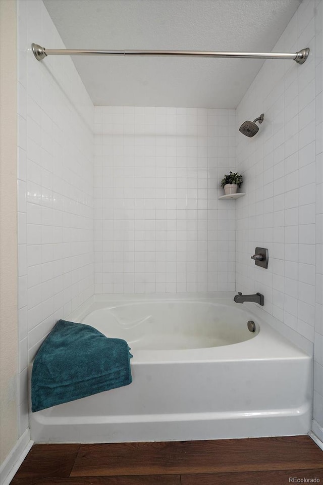 full bath with wood finished floors and shower / bathtub combination