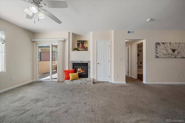 unfurnished living room featuring a tile fireplace, carpet flooring, and ceiling fan