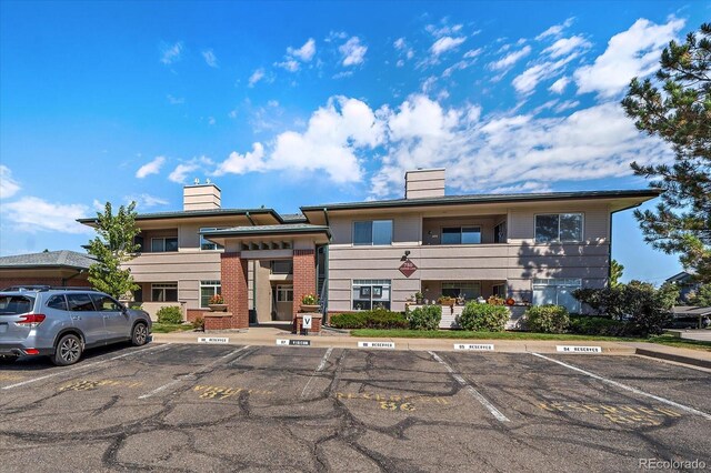 view of building exterior with uncovered parking