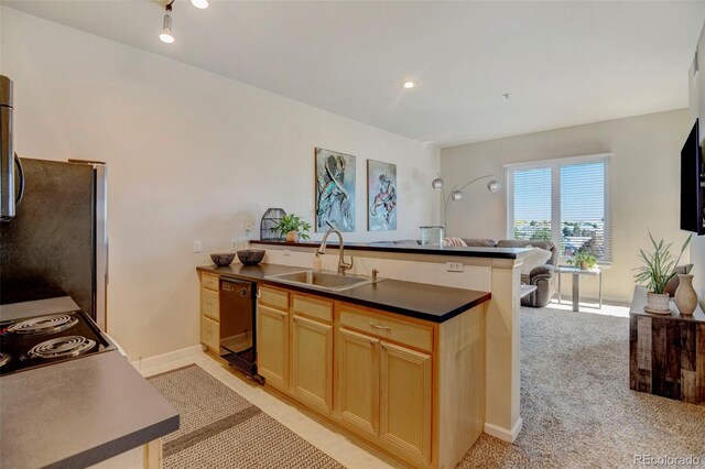 kitchen featuring light brown cabinetry, appliances with stainless steel finishes, sink, kitchen peninsula, and light colored carpet