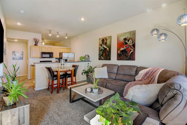 living room with track lighting and light colored carpet