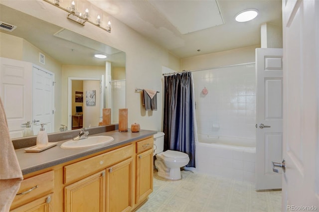 full bathroom with vanity, shower / bath combo with shower curtain, and toilet