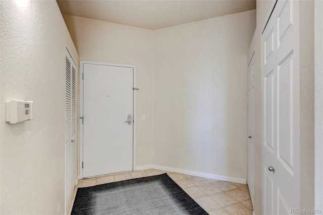 entryway with light tile patterned floors