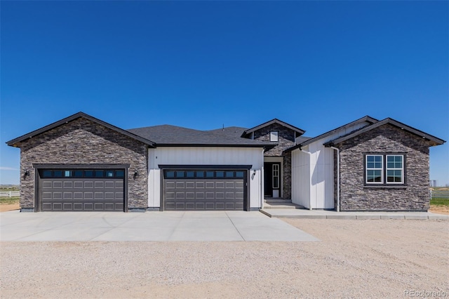56159 E Tomahawk Ave, Strasburg, CO 80136 - view of front of home with stone siding, a garage, and driveway