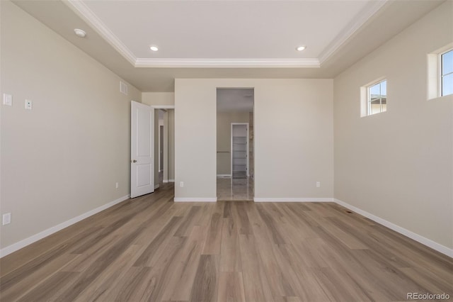 56159 E Tomahawk Ave, Strasburg, CO 80136 - unfurnished bedroom with a raised ceiling, crown molding, light wood-style floors, baseboards, and recessed lighting