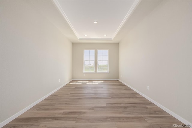 56159 E Tomahawk Ave, Strasburg, CO 80136 - spare room featuring a raised ceiling, light wood-style floors, baseboards, recessed lighting, and crown molding