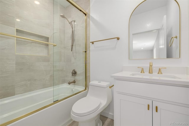 56159 E Tomahawk Ave, Strasburg, CO 80136 - full bath featuring toilet, vanity, and bath / shower combo with glass door