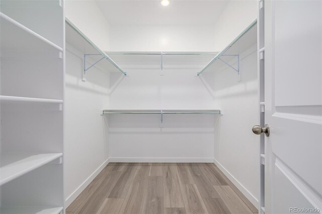56159 E Tomahawk Ave, Strasburg, CO 80136 - walk in closet featuring wood finished floors
