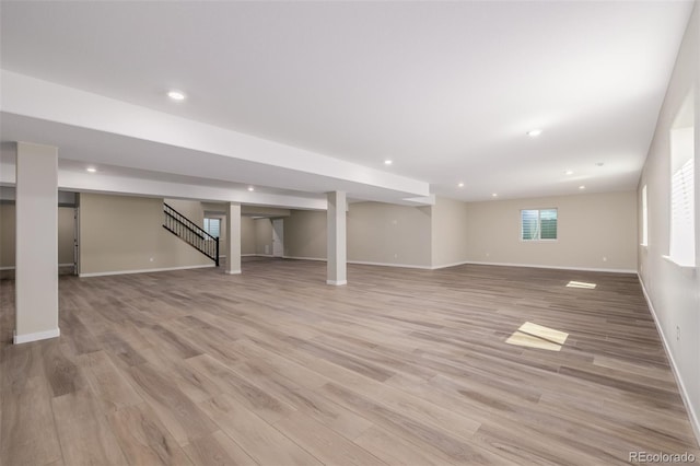 56159 E Tomahawk Ave, Strasburg, CO 80136 - below grade area featuring stairs, light wood-style flooring, baseboards, and recessed lighting