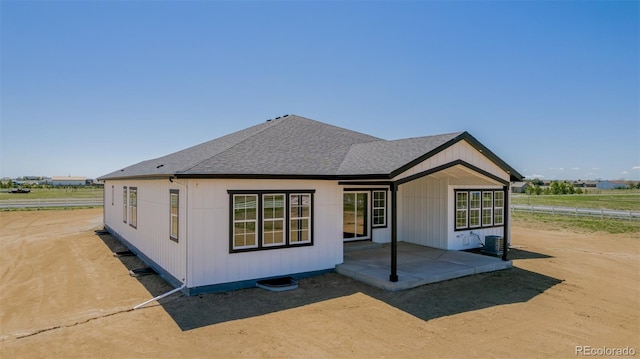 56159 E Tomahawk Ave, Strasburg, CO 80136 - rear view of property with roof with shingles, a patio area, fence, and central AC